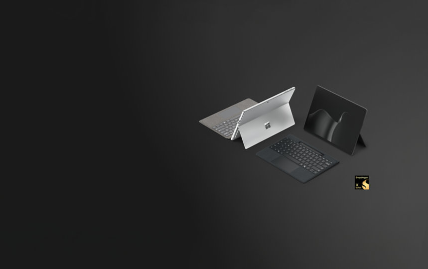 A Surface Pro for Business in the colour Platinum and a Surface Pro for Business in the colour Black, Copilot+ PCs with Snapdragon® processors, paired with the Surface Pro 13-inch Flex Keyboard for Business.