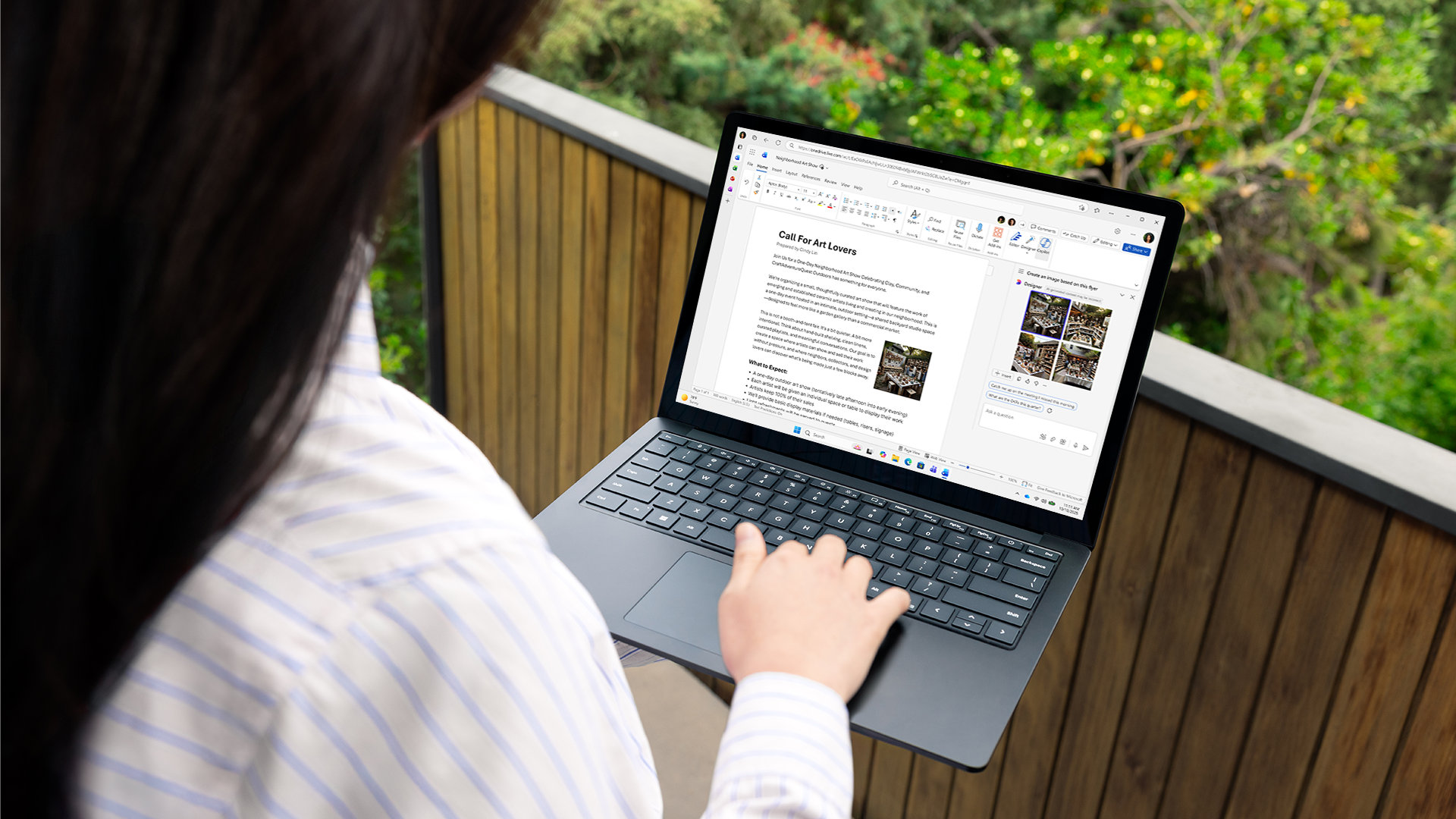 A woman using Word on a laptop while sitting outdoors.
