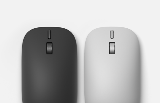 A top-down view of a Platinum Surface Mouse (2nd Edition) and a Black Surface Mouse (2nd Edition) sitting side by side.