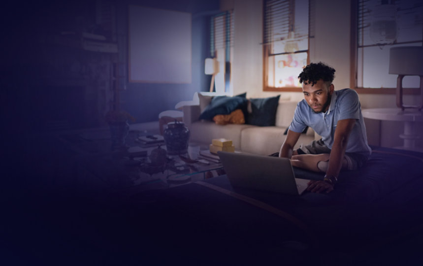 Young adult who has a prosthetic leg, watches a video on a laptop at home.