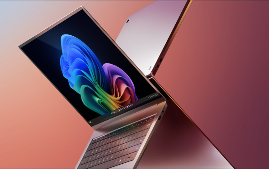 Two open laptops showing rainbow bloom design on one of the screens