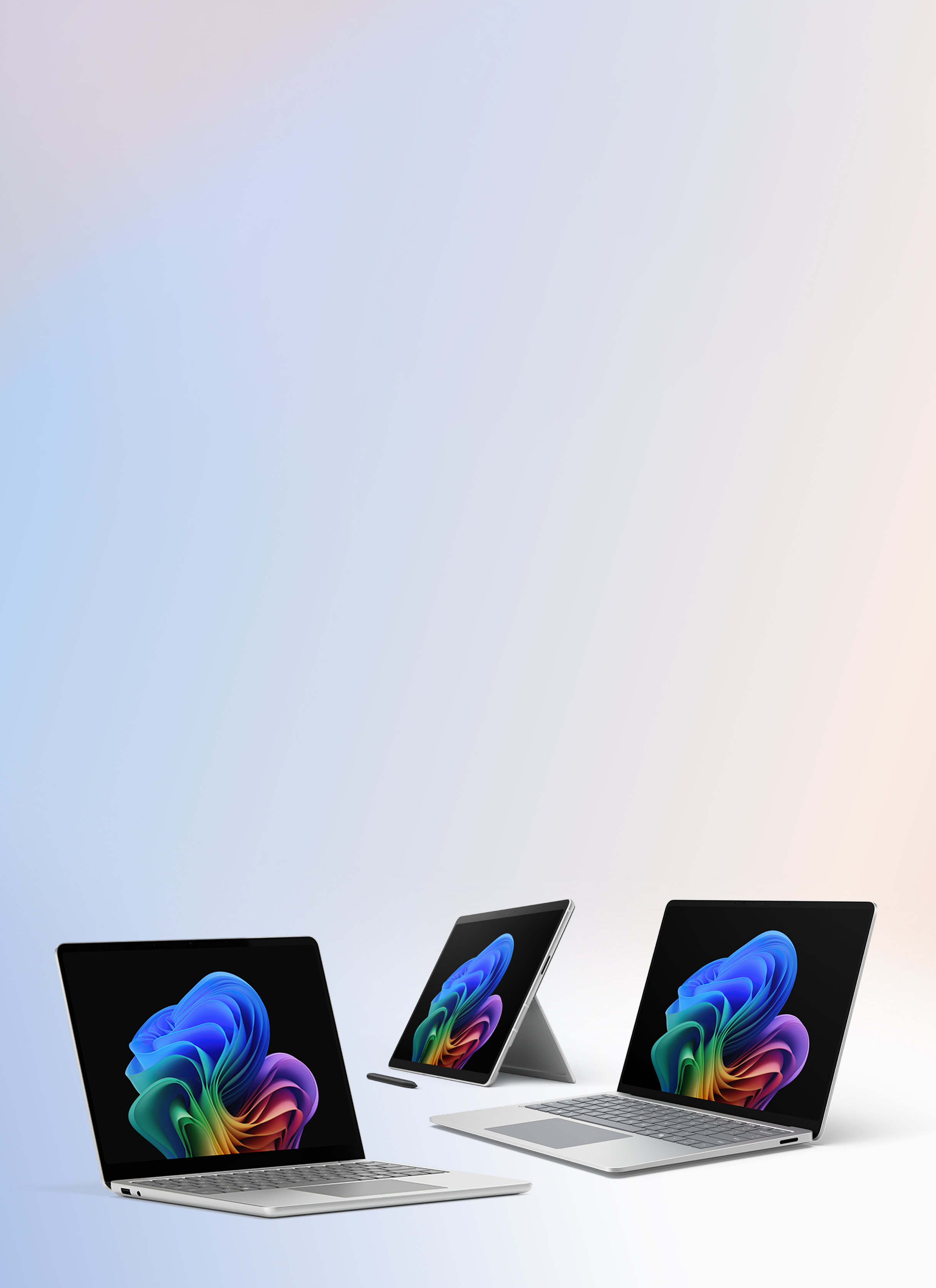 Three open Surface for Business devices, two Laptops with keyboards and one 2-in-1 device with a stylus and without a keyboard, all displaying the rainbow bloom image.